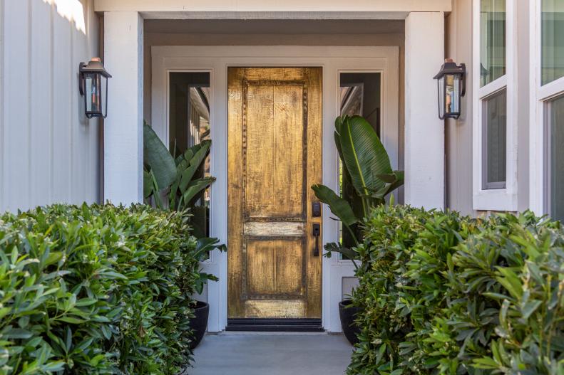 HGTV star Alison Victoria used landscaping and wrapped the front door in gold-like foil to tranform the front of her house, as seen on Rock the Block. (After)