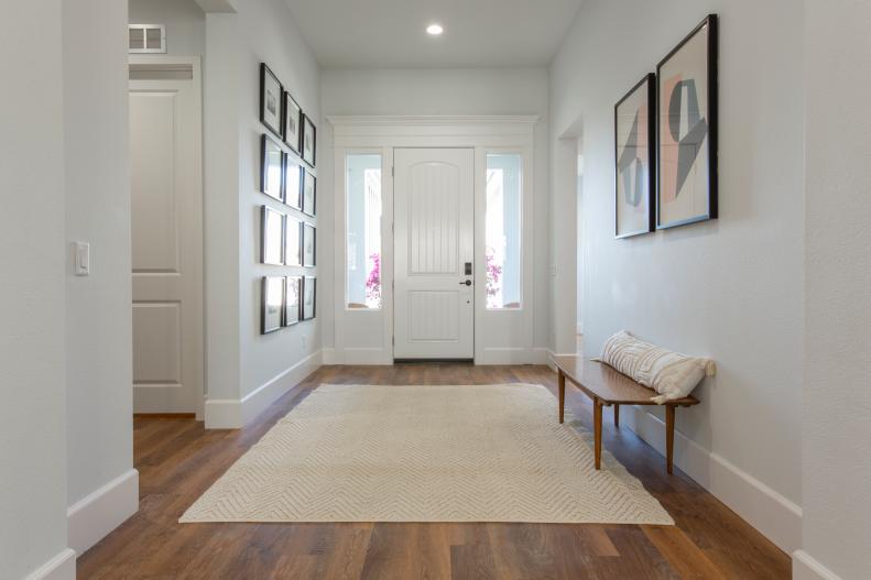 HGTV star Mina Starsiak used a wide plank wood floor and fresh paint to transform the entry way of her house, as seen on Rock the Block. (After)