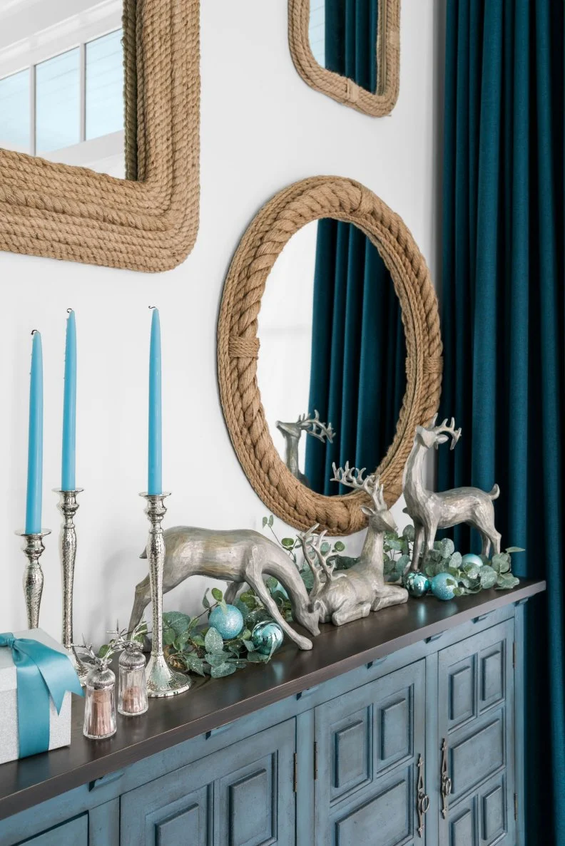 Silver Reindeer Figurines Atop Blue Dresser in Coastal Dining Room