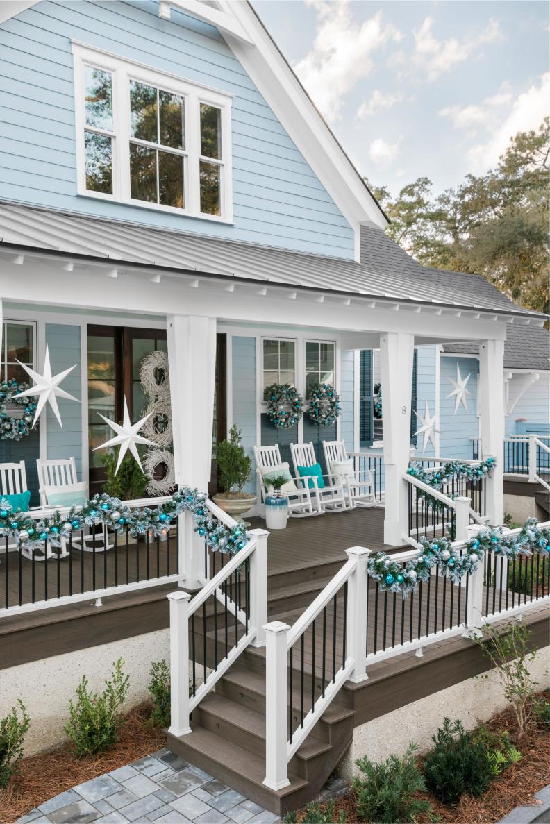 Metallic Garland Adorns Porch Railing of Blue Coastal House