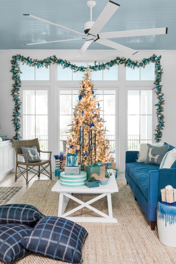 White Coastal Living Room Decorated With Tree and Garland for Holidays