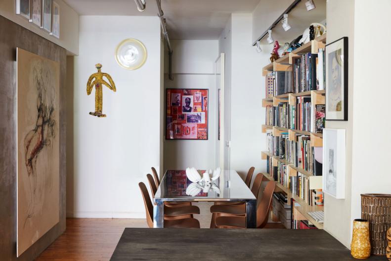 Finding room to seat six around a dining table is a challenge in just about any New York apartment. Leyden, however remembers the dining room as being one of the easiest rooms to design. The live-in art gallery feel of the home continues in this space with pieces on display on every wall and the cute ceramic banana centerpiece on the table. Though directly connected to the living room, the dining room feels distinct and separate, which is an intentional result of the design. “It’s all one space,” Leyden maintains, “with visual links and details to designate one area from the other.”  
