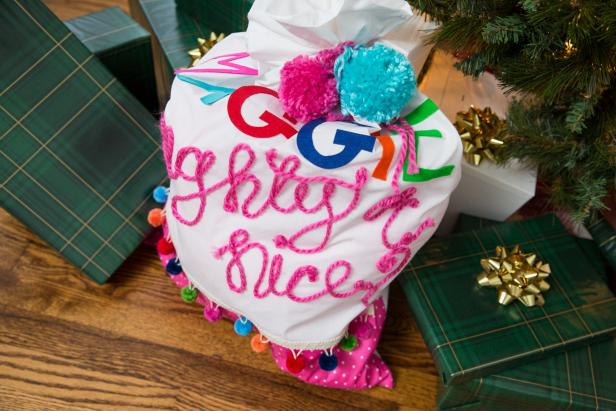 A White Pillowcase Decorated To Carry Wrapped Gifts