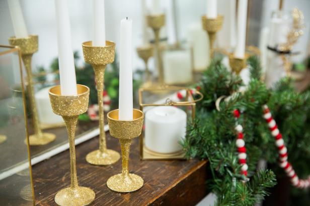 Shiny Gold Candlesticks Sitting on Top of Mantle