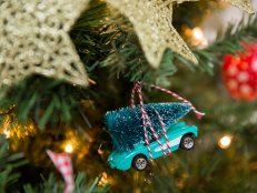 A Toy Car With a Tree Hanging On a Christmas Tree