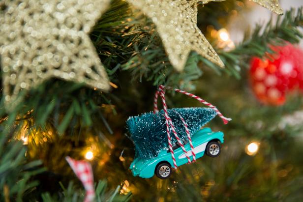 A Toy Car With a Tree Hanging On a Christmas Tree