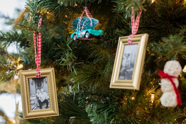 These ornaments are homemade and have been made out of inexpensive picture frames from the dollar store. The frames were painted gold and hung with ribbon.