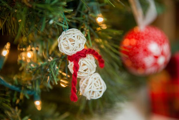 A White Snowman Ornament Hanging On a Christmas Tree