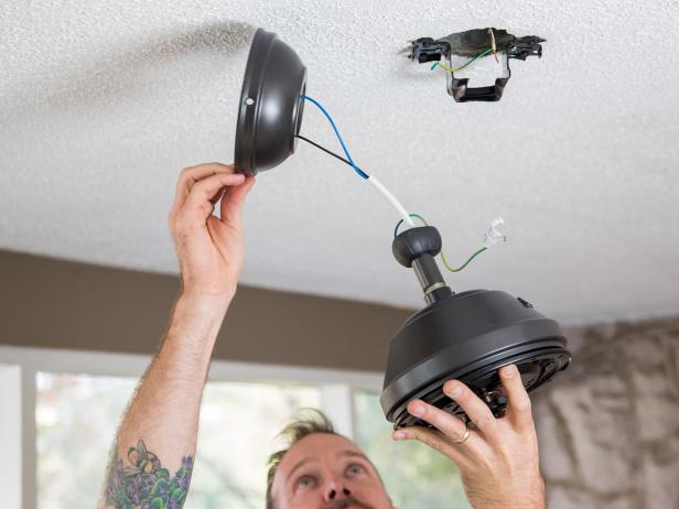 Once your bracket is attached, you’re almost ready to slide your fan onto the bracket and wire it. First, you need to pass both the mounting rod and the wires through the fan canopy. The canopy will sit against the ceiling and cover up your bracket and wiring.
