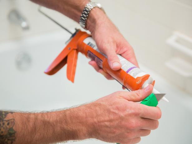 With the old caulk removed and the area cleaned, you’re ready to re-seal all the cracks and seams in your shower. Use a utility knife to cut the tip of your caulk tube at a 45-degree angle.
