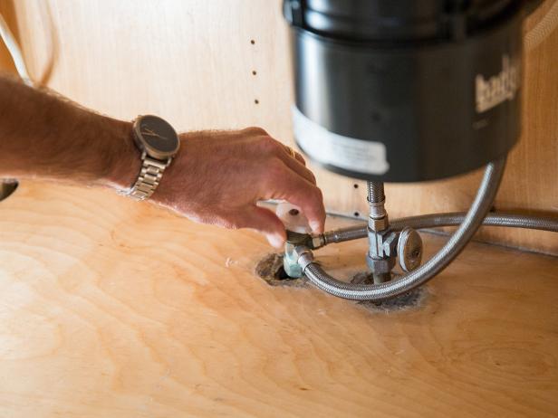 Before starting any plumbing project, you want to shut the water off at the source. In this case, you can simply turn off both the hot and cold water at the valves under your sink.
