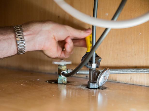 Hand tighten the supply lines to the house water and shut-off valves and then continue to tighten using an adjustable wrench.
