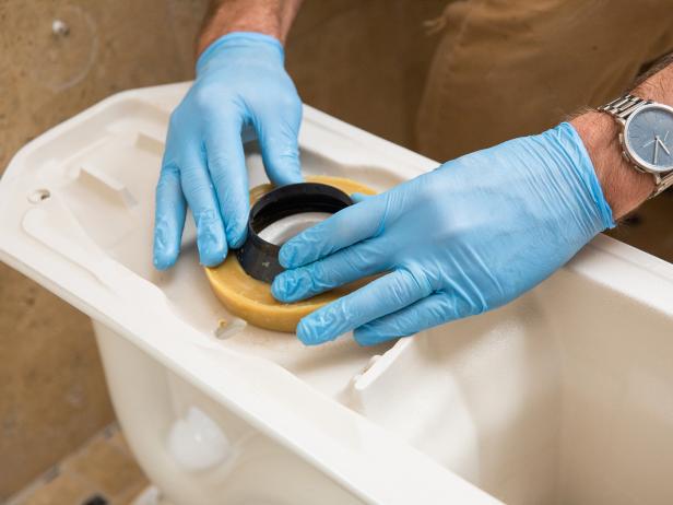 Heat up your new wax ring under warm water and place the ring firmly onto the bottom of the toilet bowl connection. Make sure the wax ring stays in place, but don’t press too hard or you’ll damage it.