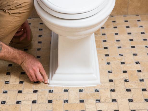 The final step is to seal around the base of the toilet with silicone caulk. It’s wise to use your toilet for a day or two before applying the silicone. You want to be extra sure there are no leaks from the base. Once you’re certain everything is installed correctly, run a bead of silicone caulk around the base of the toilet. You can use your finger as a trowel to create a smooth seam.