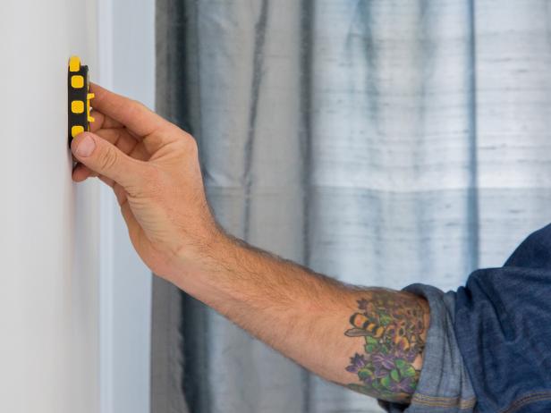 Use a stud finder to locate each 2x4 stud in the wall.