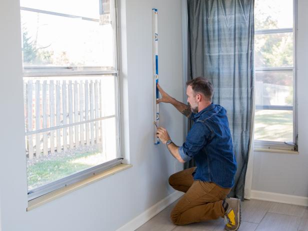 Use a stud finder to locate each 2x4 stud in the wall. They should be about 16” apart. Use your 4’ level to mark the location of each stud on the wall.