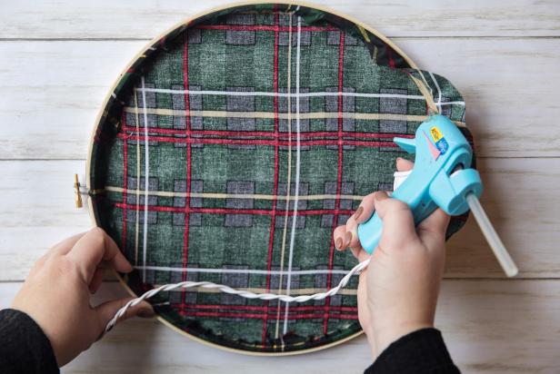 Flip the wreath over and place a line of hot glue on a small section of the inside hoop.