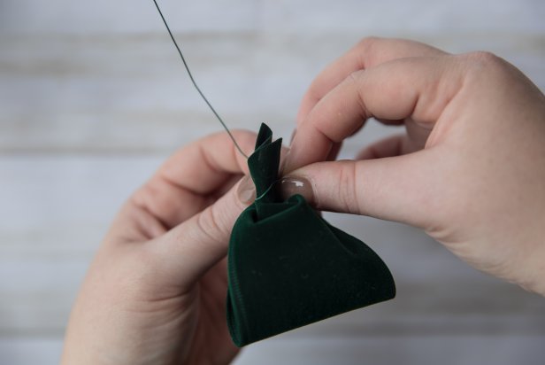 For the emerald green loops, create the illusion of a bow by making a small loop and twisting the ends with floral wire.