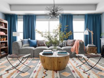 Inspired by the earthy orange tones, cool blues and warm grey-brown of the HGTV Dream Home 2020 great room, Kristen and Dwight's redesigned family room is now packed with practical storage solutions, plenty of seating, happy colors and a space plan that maximizes every square inch.