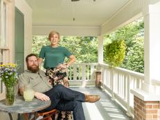 As seen on Home Town, Ben and Erin Napier (R) enjoy the covered porch of the newly renovated Guay home in Laurel, Mississippi. On the exterior, the old pipe columns have been removed and new wood columns and decorative railing has been installed.  New paint, landscaping and new porch roofing help to improve the exterior. (portrait)