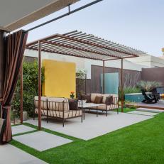 Modern Patio with Metal Pergola and Dining Space