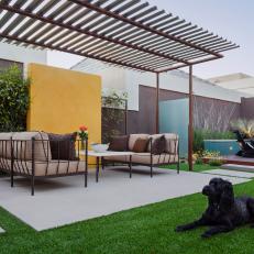 Neutral Toned Patio with Pergola and Yellow Accent Wall