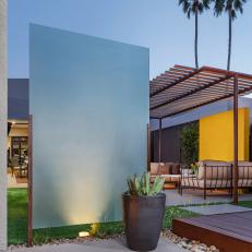 Bold Blue Accent Wall with Cacti in Rusticated Steel Planter