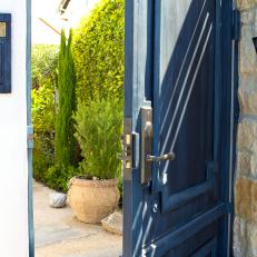 Blue Front Door With Stone Accent Wall