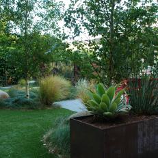 Lush Backyard With Steel Planter 