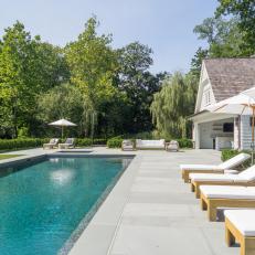 Lengthy, Modern Swimming Pool With Blue Pebble Finish