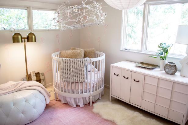 As seen on Restored by the Fords, the renovated interior bedroom of the Collins House featuring custom pink flower wall decorations and butterfly chandelier 