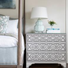 Nailhead Dresser and Blue Upholstered Four-Poster Bed in Master Bedroom
