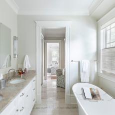 Master Bathroom in Neutral Marble and White With Soaking Tub