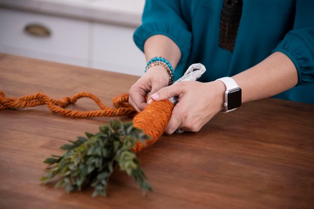 Wrap the dyed twine around the top of the carrot, using a glue gun to secure into place, and continue all the way down.