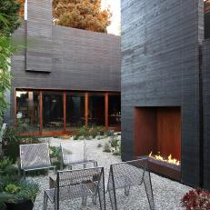 Modern Industrial Outdoor Sitting Area With Fireplace
