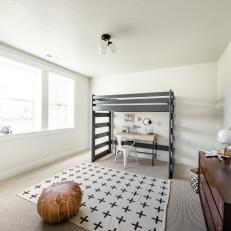 Bedroom With Black-and-White Pattern Rug, Loft Bed Over Desk and Chair