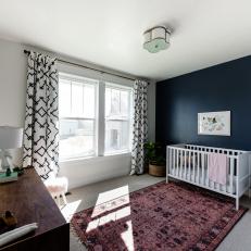 Nursery With Black Accent Wall, Black and White Curtains, Bold Rug