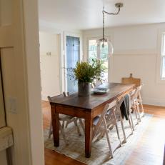 White Cottage Dining Room with Hardwood Brown Floors
