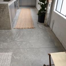 Urban Gray Kitchen with a Gray Concrete Floor and Neutral Rug 