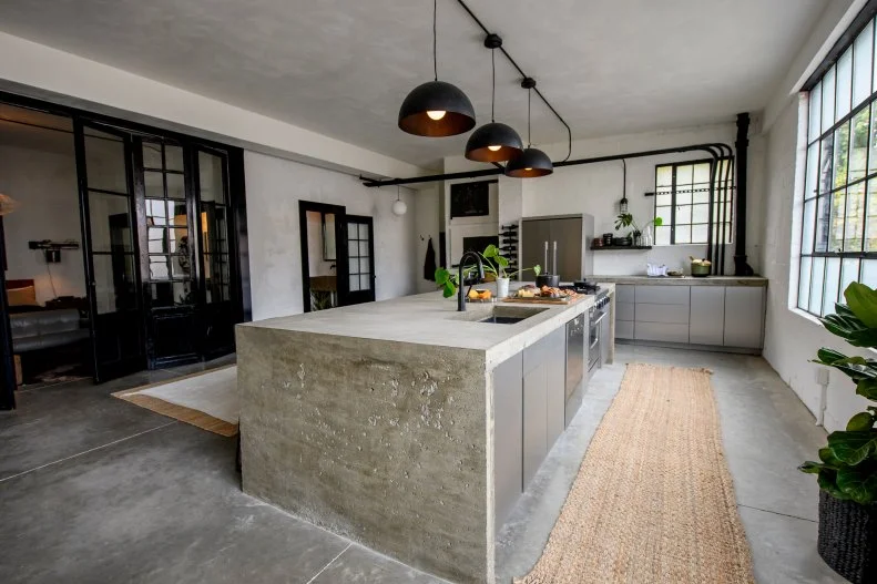 Gray Kitchen with Gray Concrete Floors and Neutral Rugs 