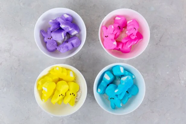 To make Peeps candy slime, first add 1 tablespoon coconut oil to each bowl. Then, add same-colored candy to individual bowls. Melt the candy by microwaving the candy in a microwavable bowl for 30-seconds. Add two tablespoons of cornstarch, then mix together. Make ropes of each other. Then twist them together to make rainbow Peeps candy slime.