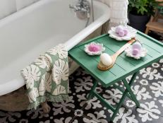 In just a few steps, you can easily upcycle an old luggage rack (that you probably never use, anyway) into a handy folding table that's just the right height to keep spa essentials or a glass of wine handy while you soak in the tub.