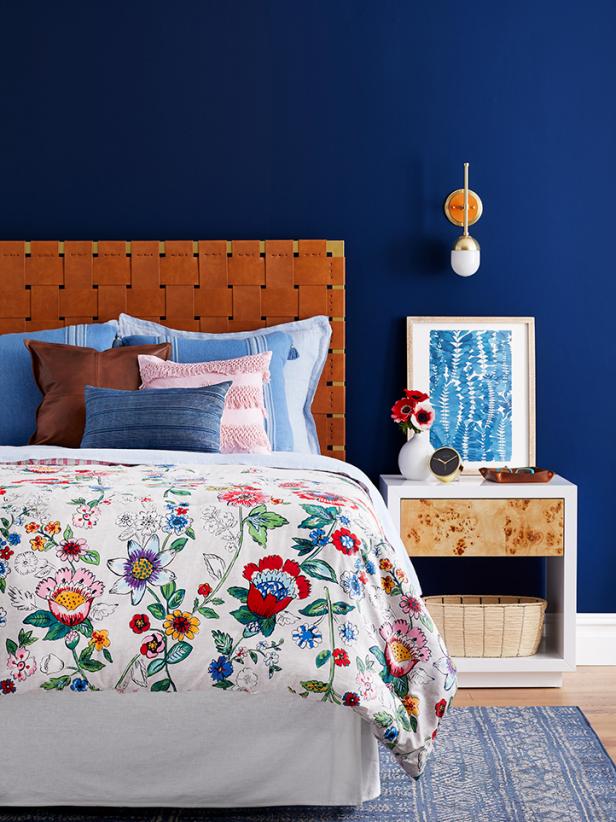 A bedroom that mixes floral and leather