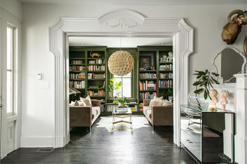 The book and curio-laden shelves in Tracy Galasso's Atlanta home define this formal-meets-funky parlor.