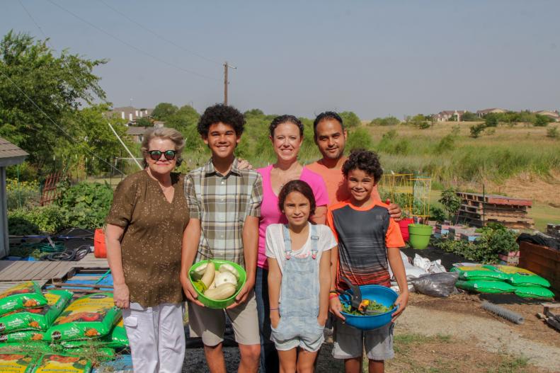 The Anthis family poses with their most recent harvest in their backyard vegetable garden as seen on One of a Kind.