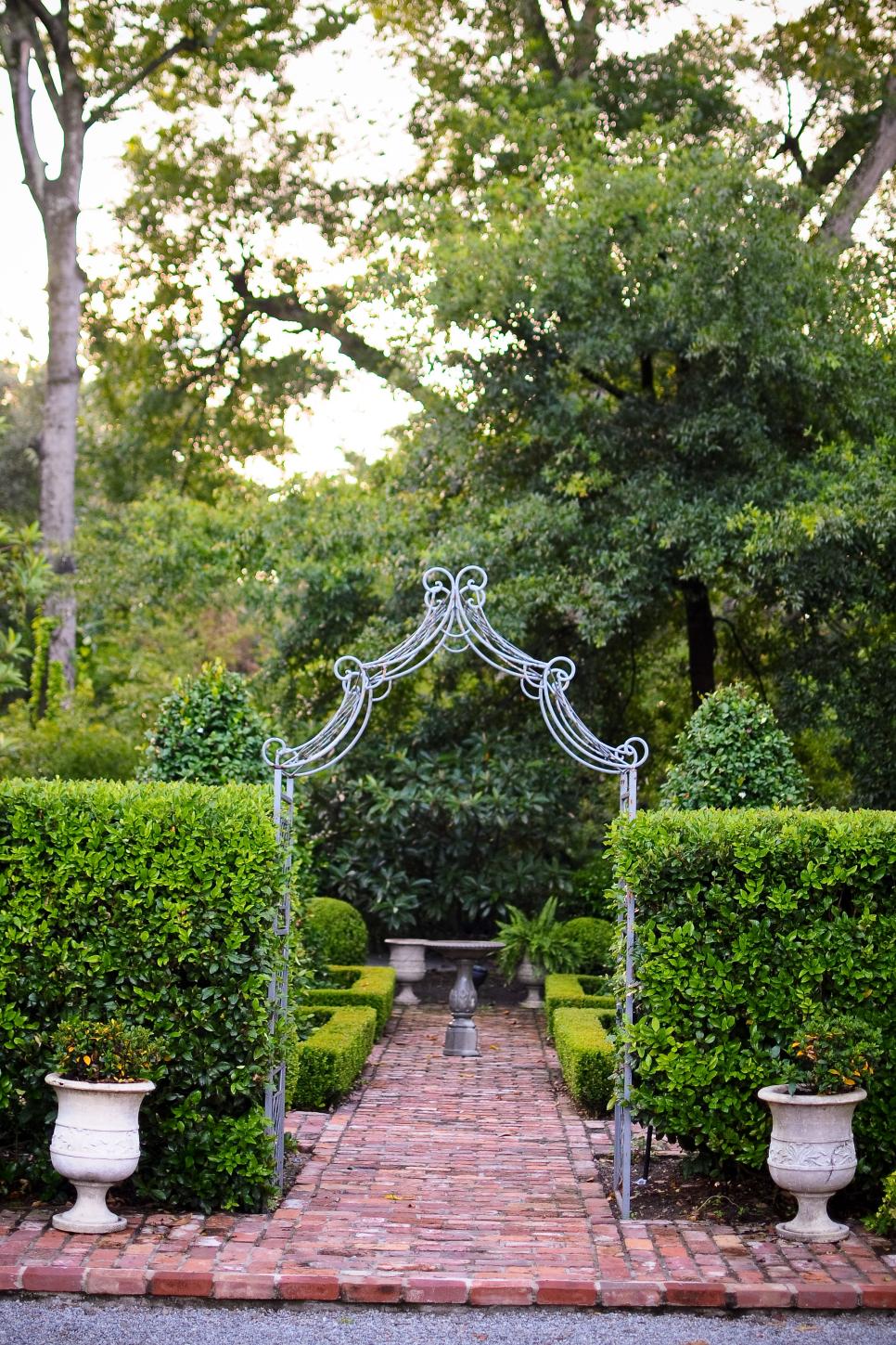 Metal Arbor Entrance to Brick Garden | HGTV