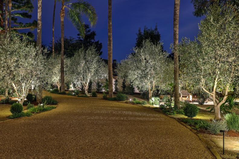 Mediterranean villa with gravel driveway at night