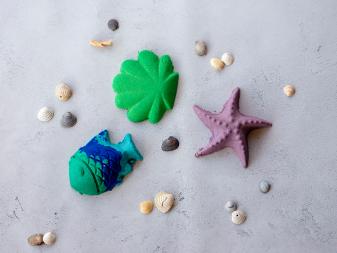 Colorful sea sand shapes and shells on a table