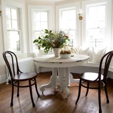 Contemporary White Breakfast Nook with White Bench and Brown Chairs 