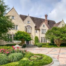 European-Style Manor Home in Dallas Offers Strong Curb Appeal With Landscaping, Brick Drive